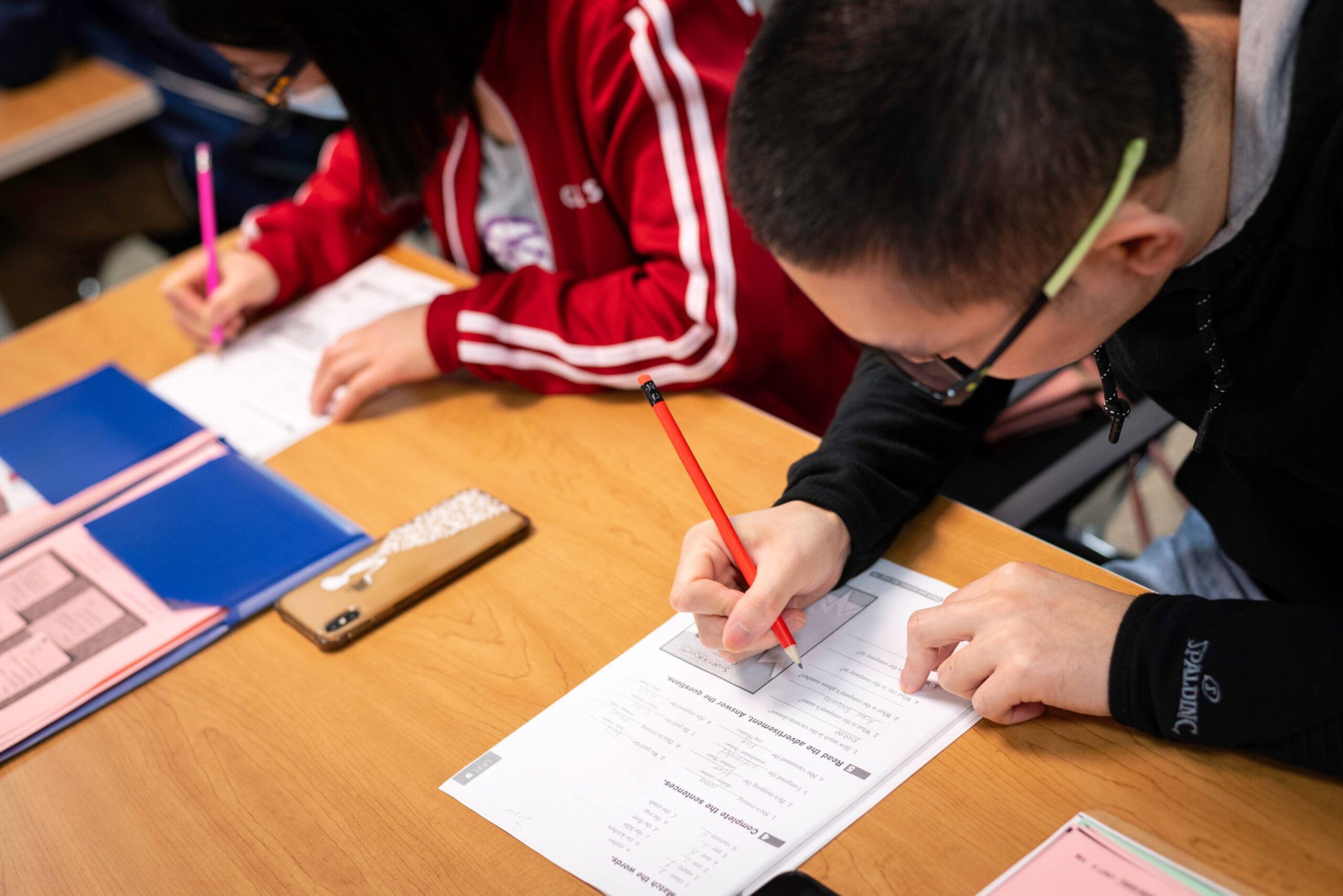 A student is writing on a worksheet
