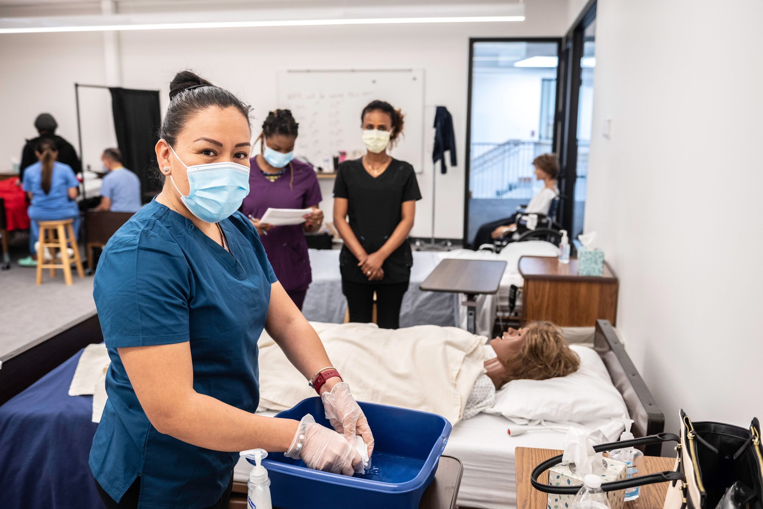 Adult education student practicing basic health care skills